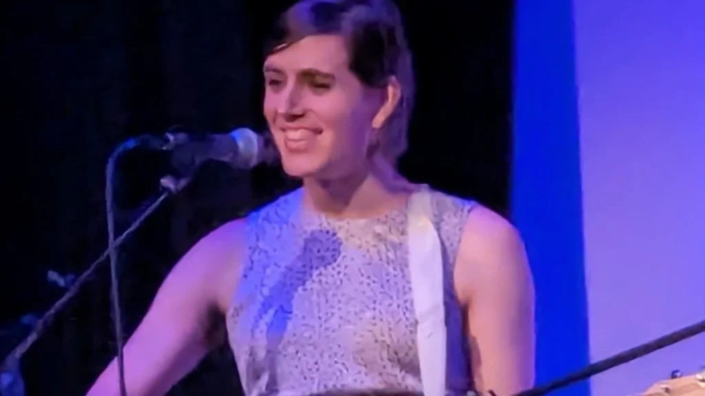 Ezra Furman singing on stage at a microphone