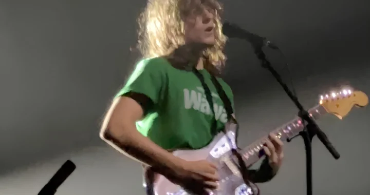 Mk.gee performing live with a Fender guitar