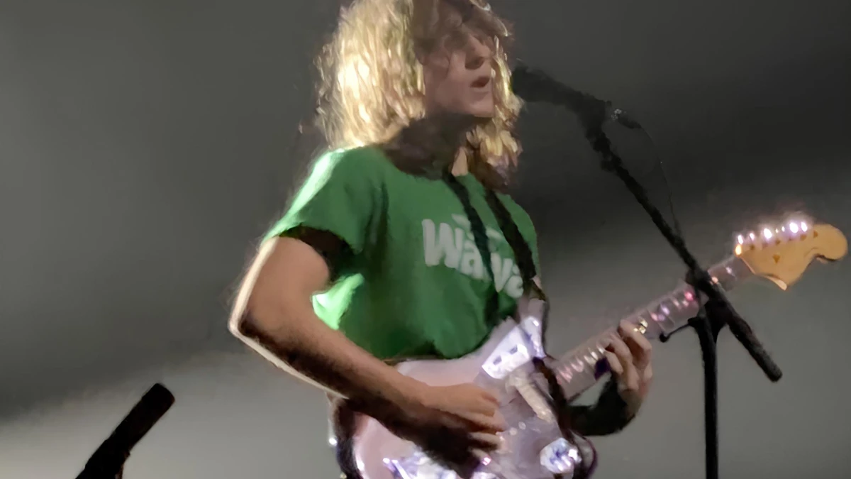 Mk.gee performing live with a Fender guitar